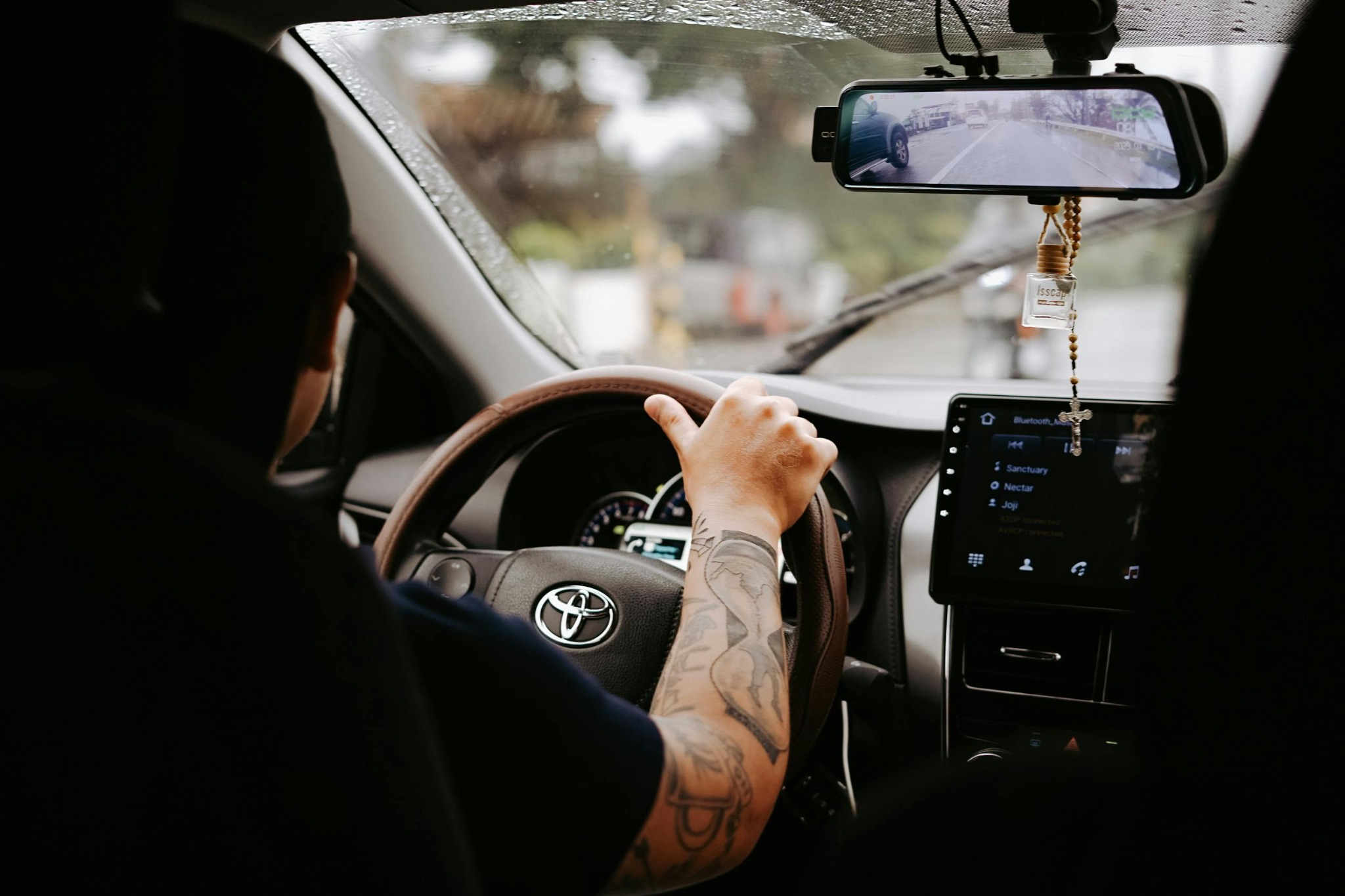 Interior vehicle view with dash cam and infotainment accessories installed for road use.